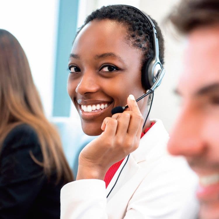 Woman talking on headset in call centre