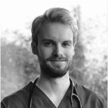 Photo of young man who appears to be a doctor.