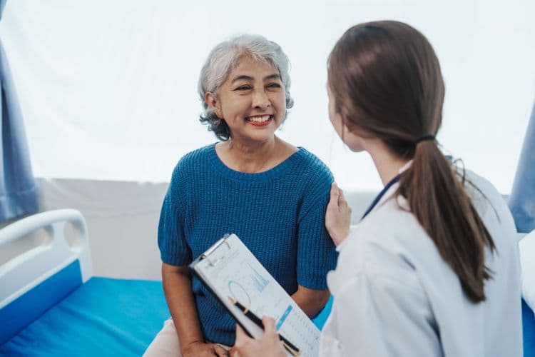 Woman being informed by a Bluecrest Health Assessor what a female cancer risk check involves