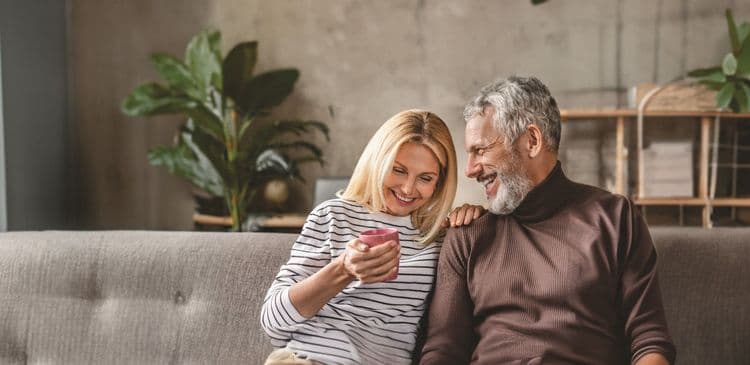 A man and woman having a conversation and laughing.