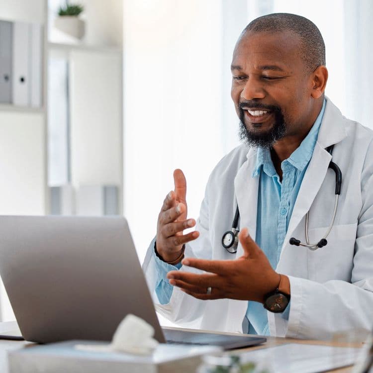 GP having a private health consultation with a Bluecrest Wellness customer on a laptop