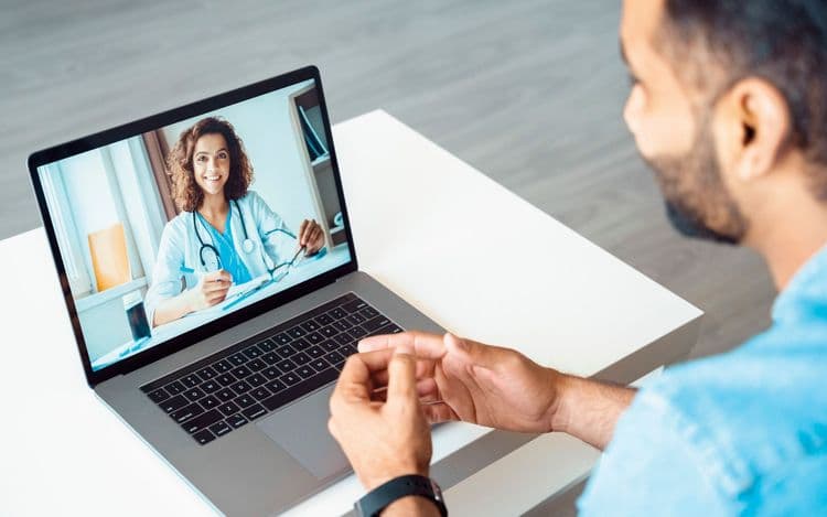 Man in a virtual doctor's appointment on his phone.